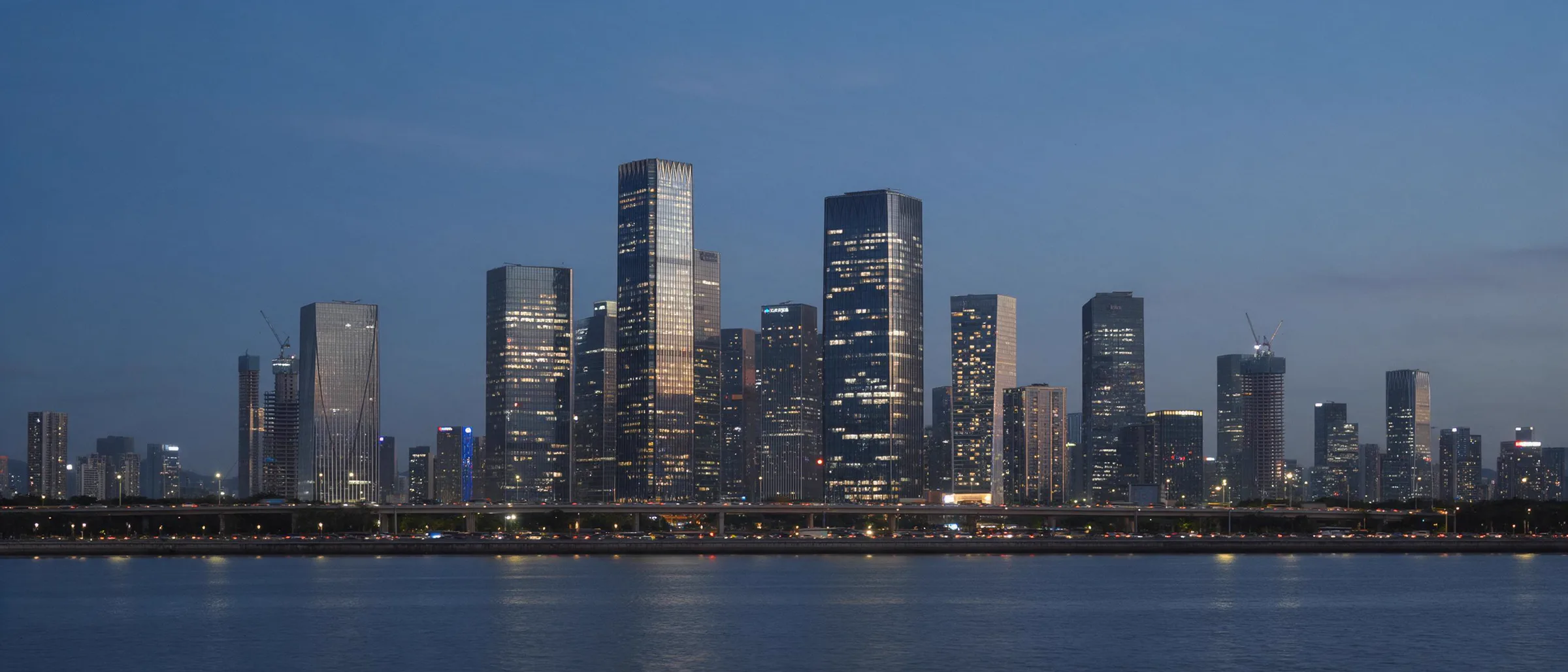 City skyline across a bay at dusk